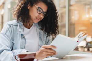 Young african-american student freelancer businesswoman teenager doing homework, project